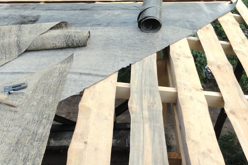 Roofing felt being laid over roof boards