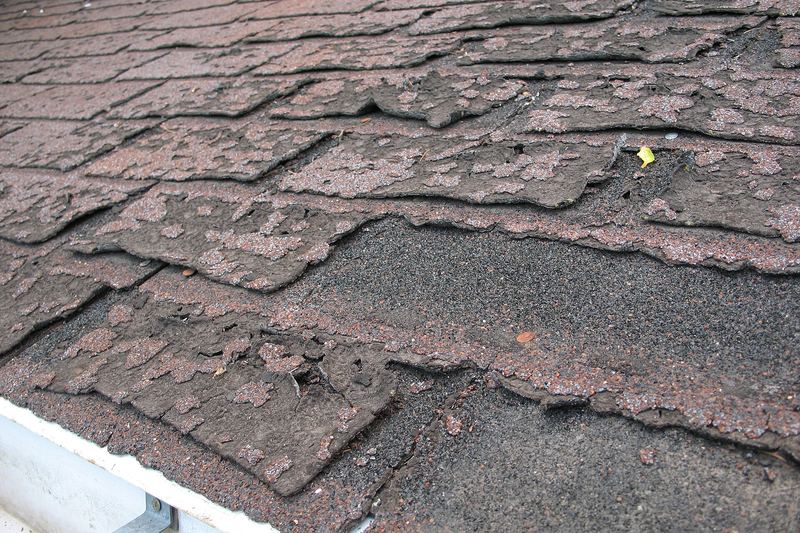Worn asphalt shingles that let water into the roof
